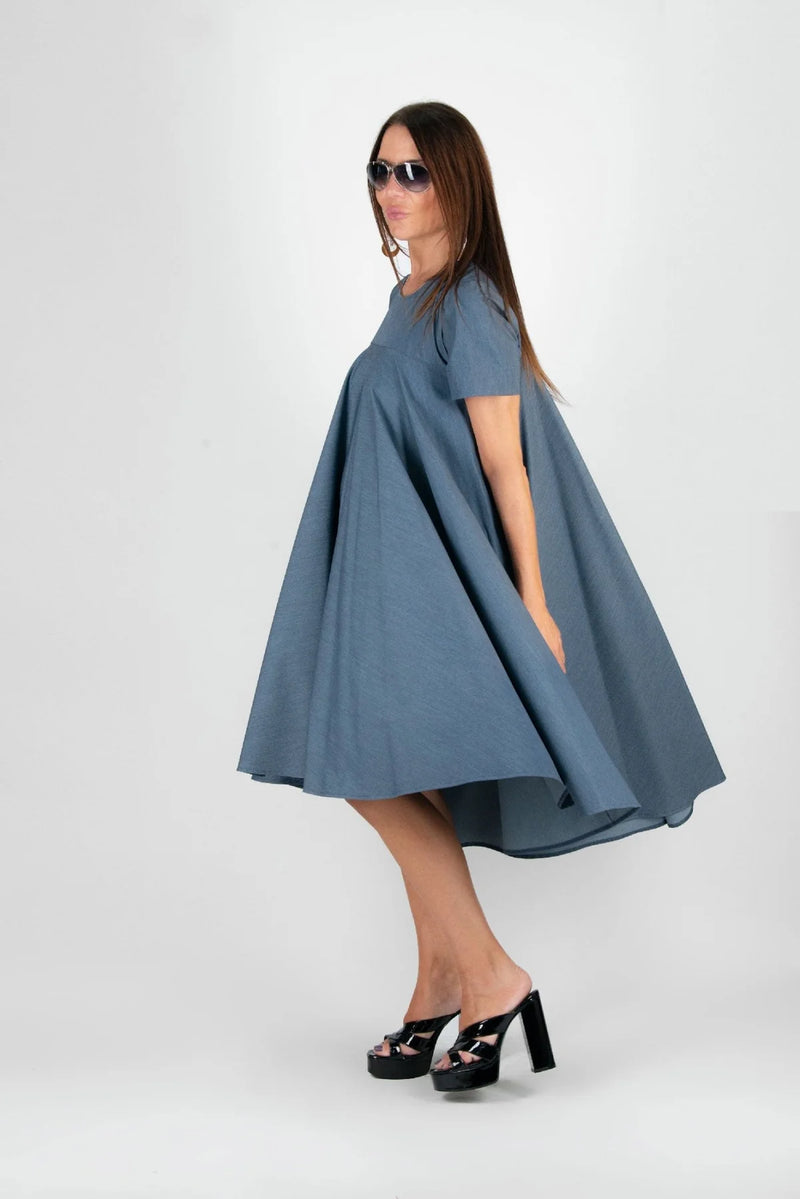 Side view of a model wearing the dress, highlighting the flattering A-line silhouette and short sleeves.