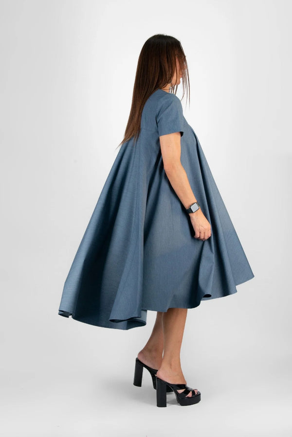 Side view of a model wearing the dress, highlighting the flattering A-line silhouette and short sleeves.