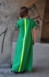 Model wearing DFold Clothing AMIRA Long Summer Dress With Back Stripe in Green, back view.