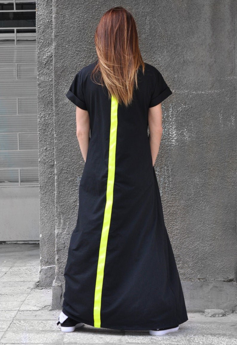 Model wearing DFold Clothing AMIRA Long Summer Dress With Back Stripe in Black, back view.