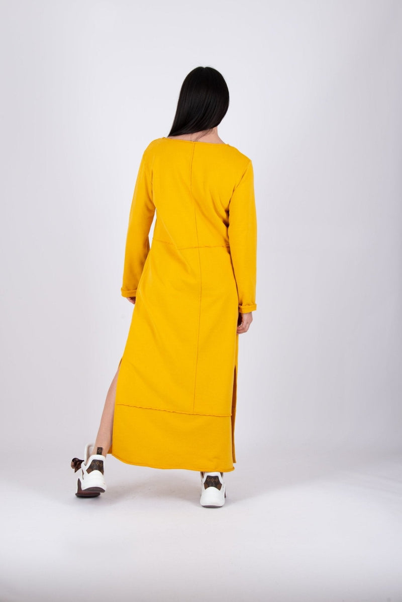Long Dress GABRIELLE - Back View: Model showcasing the back of the yellow cotton dress with raw edges.
