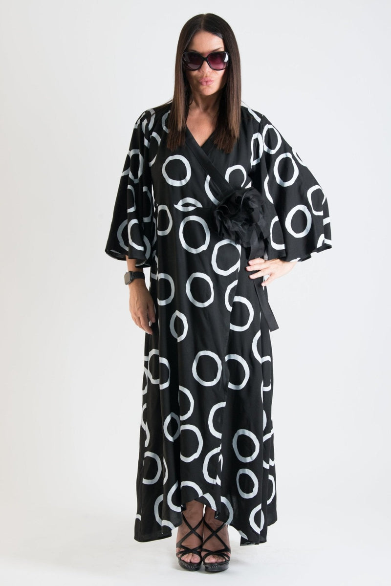  ASTRID Summer Maxi Dress - Image showing a model wearing a floral wrap-up maxi dress with wide sleeves and a belt closure.