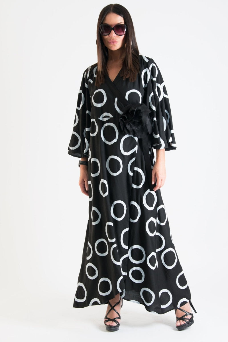  ASTRID Summer Maxi Dress - Image showing a model wearing a floral wrap-up maxi dress with wide sleeves and a belt closure.