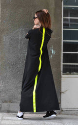 Model wearing DFold Clothing AMIRA Long Summer Dress With Back Stripe in Black, back view.