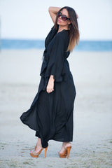ASTRID Summer Maxi Dress - Image showing a model wearing a floral wrap-up maxi dress with wide sleeves and a belt closure.