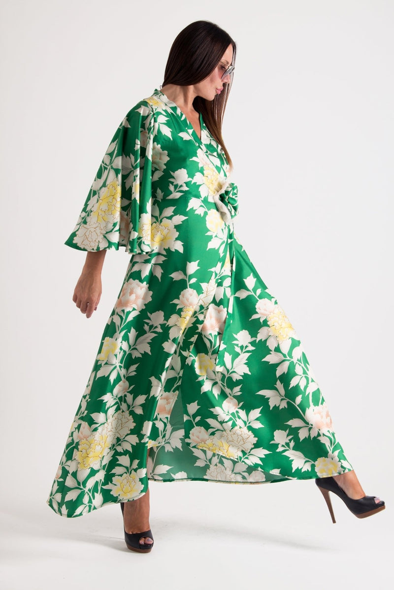 ASTRID Summer Maxi Dress - Image showing a model wearing a floral wrap-up maxi dress with wide sleeves and a belt closure.